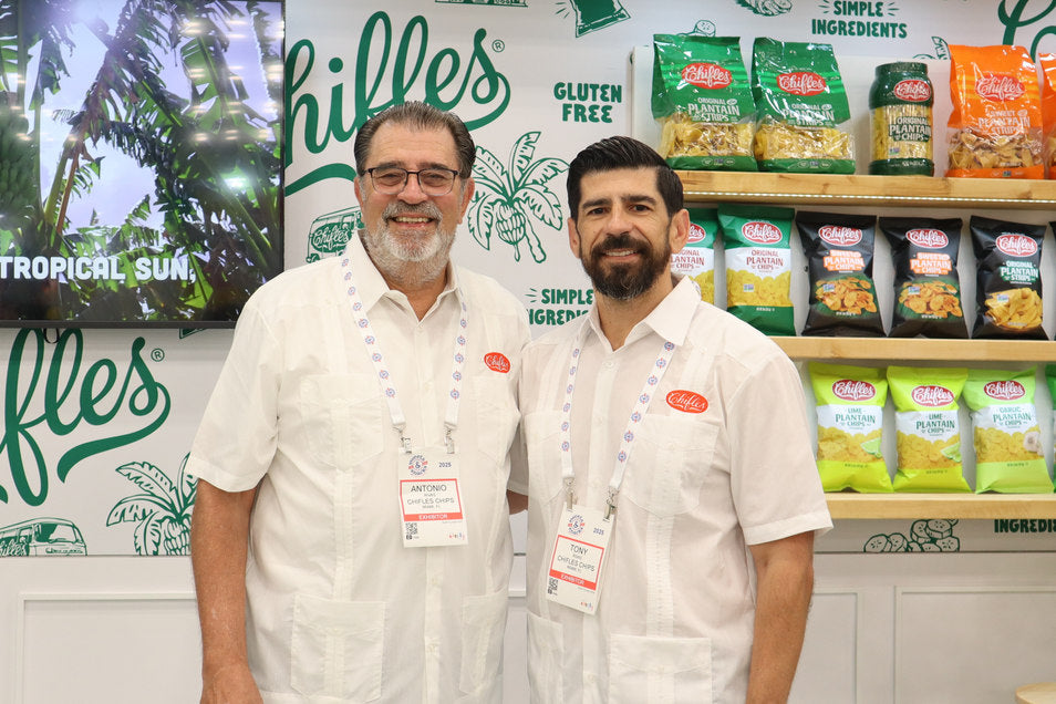 Antonio and Tony Rivas at the Chifles trade show booth surrounded by plantain chip bags